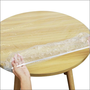 Elastic table cover bags set being placed on a round wooden table for easy use and protection