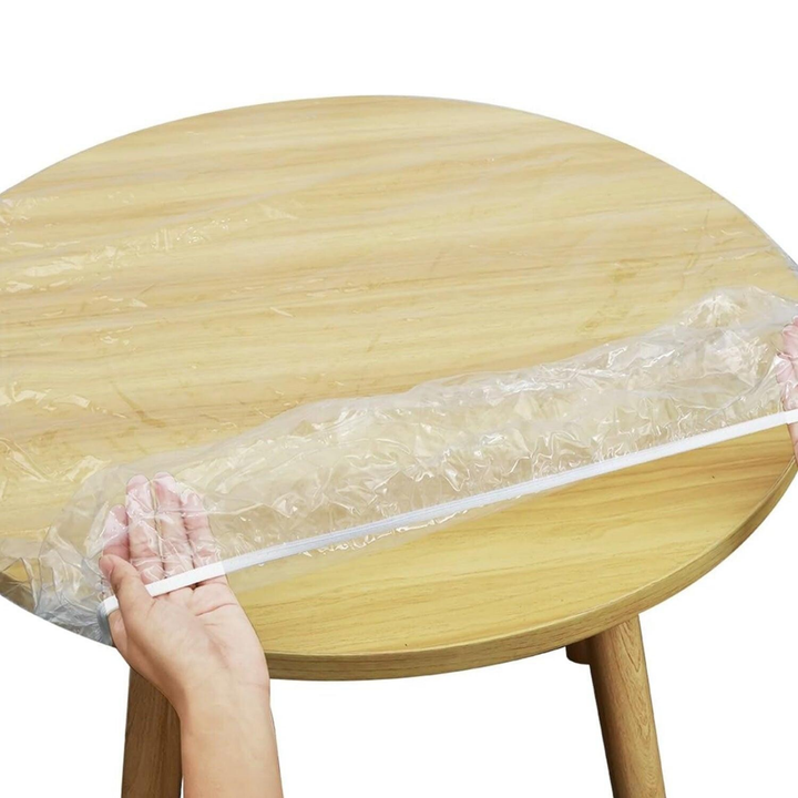 Elastic table cover bags set being placed on a round wooden table for easy use and protection