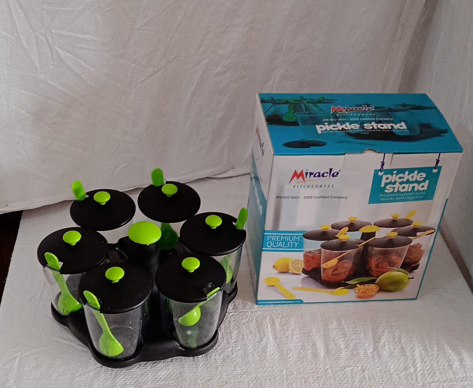 Revolving spice rack set with clear containers and green lids for easy access and organization