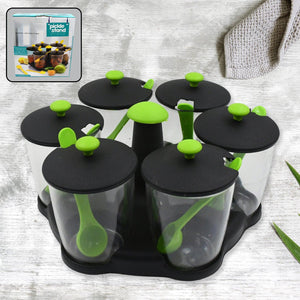 Revolving spice rack set with clear containers and green lids for easy seasoning access in the kitchen