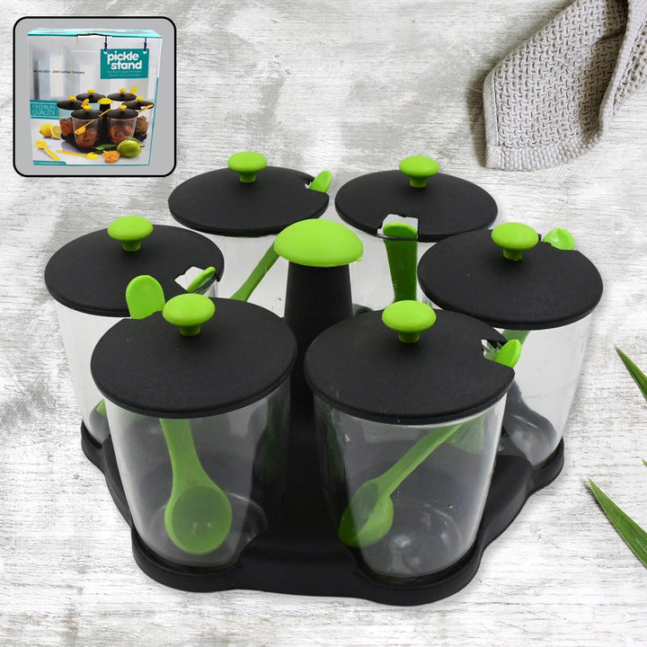 Revolving spice rack set with clear containers and green lids for easy seasoning access in the kitchen