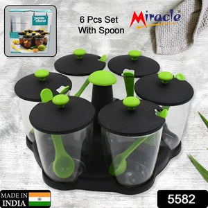 Revolving spice rack set with six containers and spoons for organized kitchen storage
