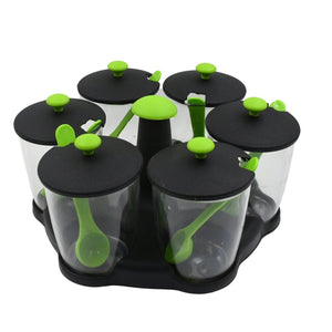 Revolving spice rack set with glass containers and green measuring spoons for easy seasoning access