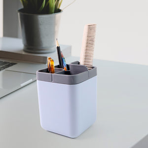 Superior eMart multi compartment desk organizer in white and gray holding pens and a comb on a white desk