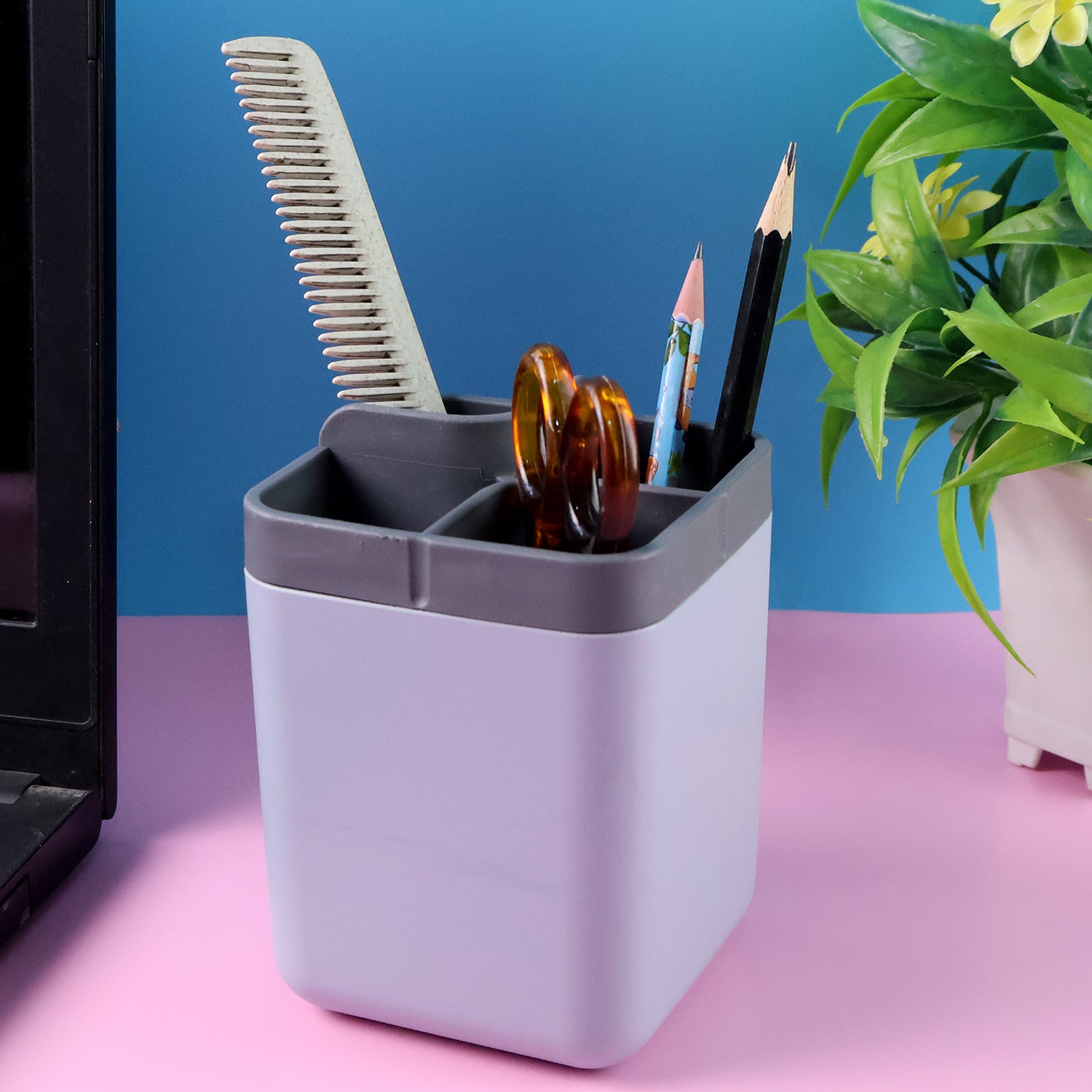 Superior eMart multi compartment desk organizer holding comb scissors and pencils on pink surface