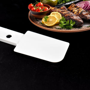 Multi-purpose cleaning brush next to grilled vegetables and meats on a platter for kitchen use