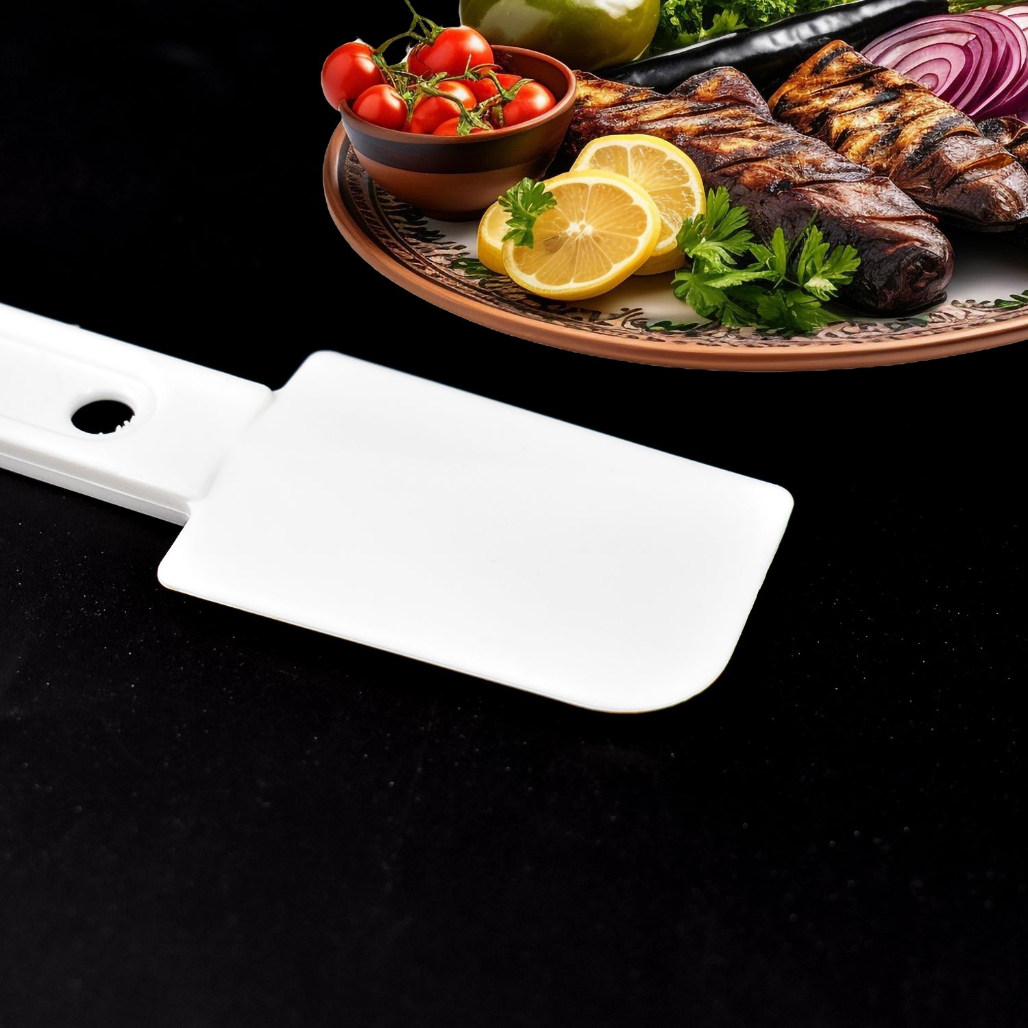 Multi-purpose cleaning brush next to grilled vegetables and meats on a platter for kitchen use