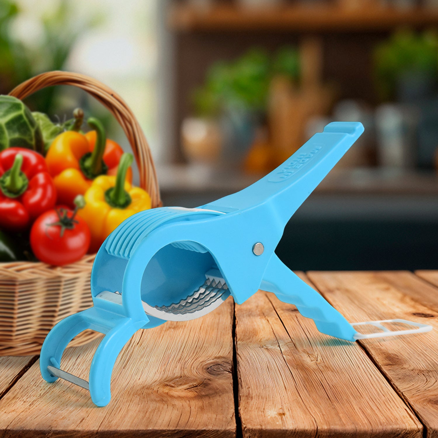 Blue multi-purpose vegetable cutter by Superior eMart on wooden table with fresh vegetables in background