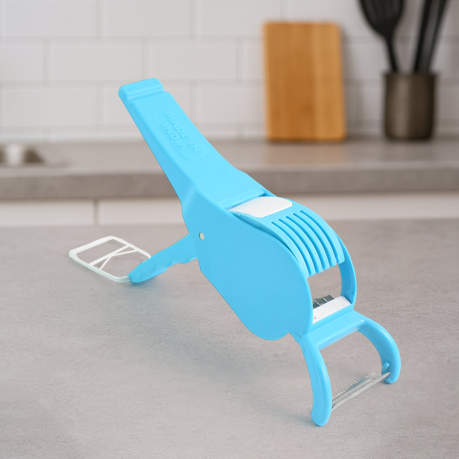 Blue multi-purpose vegetable cutter from Superior eMart placed on a kitchen countertop