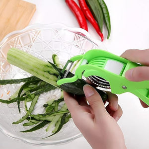 Superior eMart multi-purpose vegetable cutter peeling cucumber over glass bowl with red and green chili peppers nearby