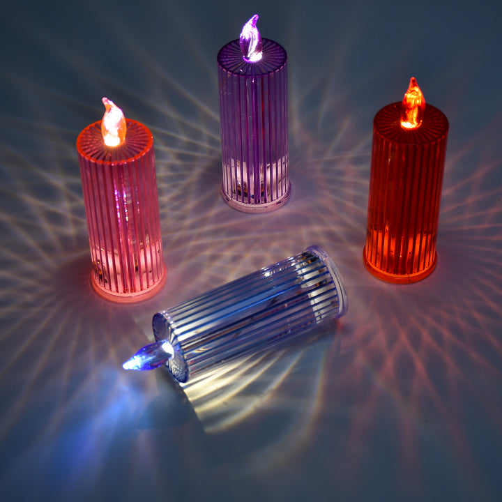 Multicolor crystal candle lights in various colors casting vibrant reflections on a surface