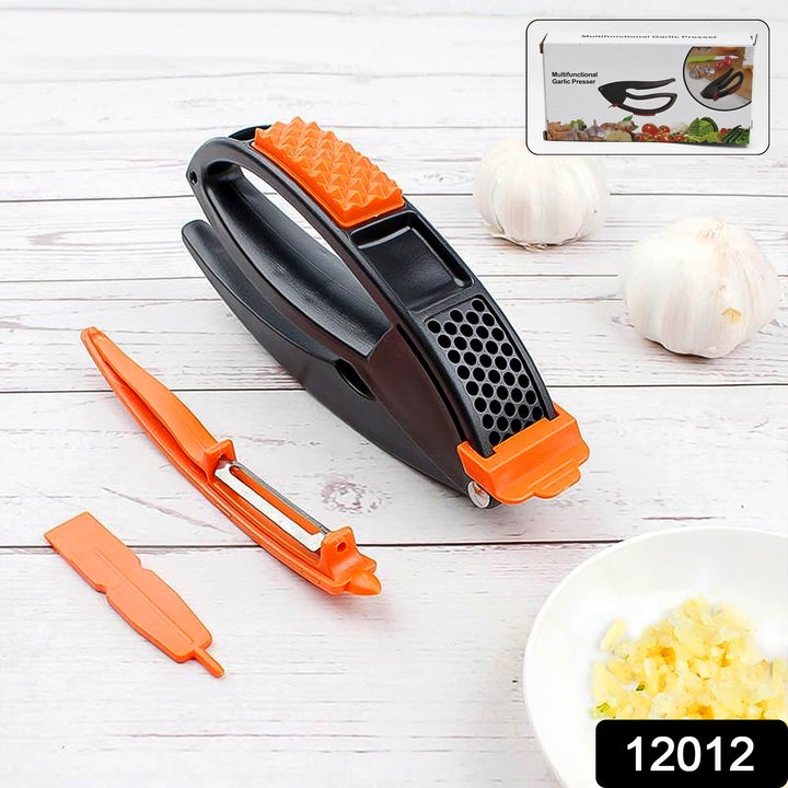 Superior eMart multifunctional garlic press with black and orange handle and peeler tool on white wooden surface