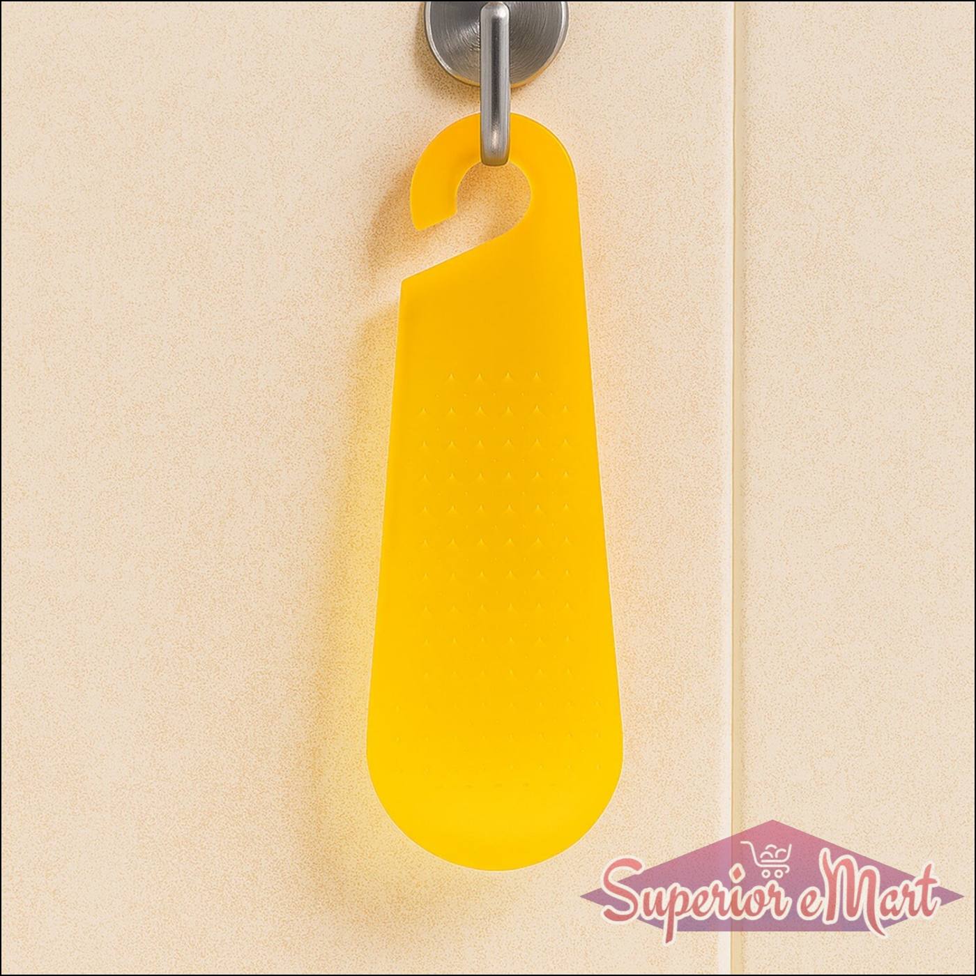 Bright yellow garlic and ginger grater tool hanging on a kitchen wall for easy access