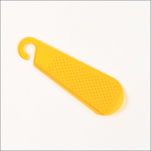 Yellow garlic and ginger grater tool with a textured surface for efficient grating