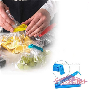 Hands using colorful plastic pouch sealer clips to seal bags of fruits and vegetables