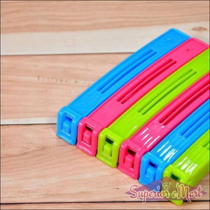 Colorful plastic pouch sealer clips in pink, blue, and green for sealing food bags securely