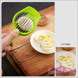 Green multipurpose slicer for fruits and eggs with a hand holding it over sliced eggs on a plate
