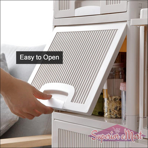 Hand opening the drawer of a multipurpose storage cabinet with drawers in a modern kitchen setting