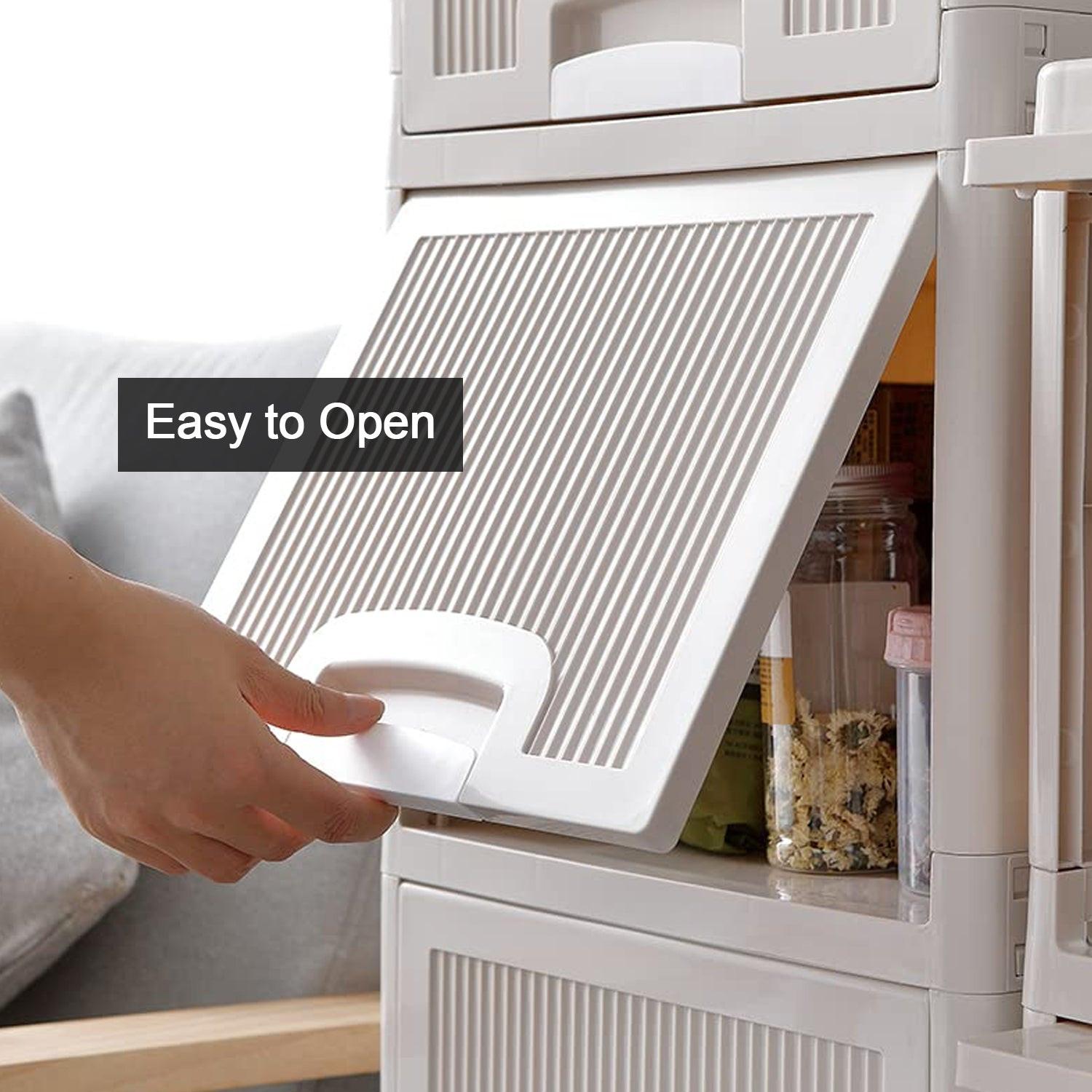 Hand opening the drawer of a multipurpose storage cabinet with drawers in a modern kitchen setting