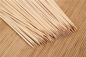 Natural bamboo skewers in a bundle on a textured surface for grilling and cooking