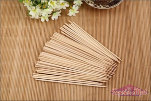 Pack of natural bamboo skewers on a wooden surface, ideal for grilling and cooking.