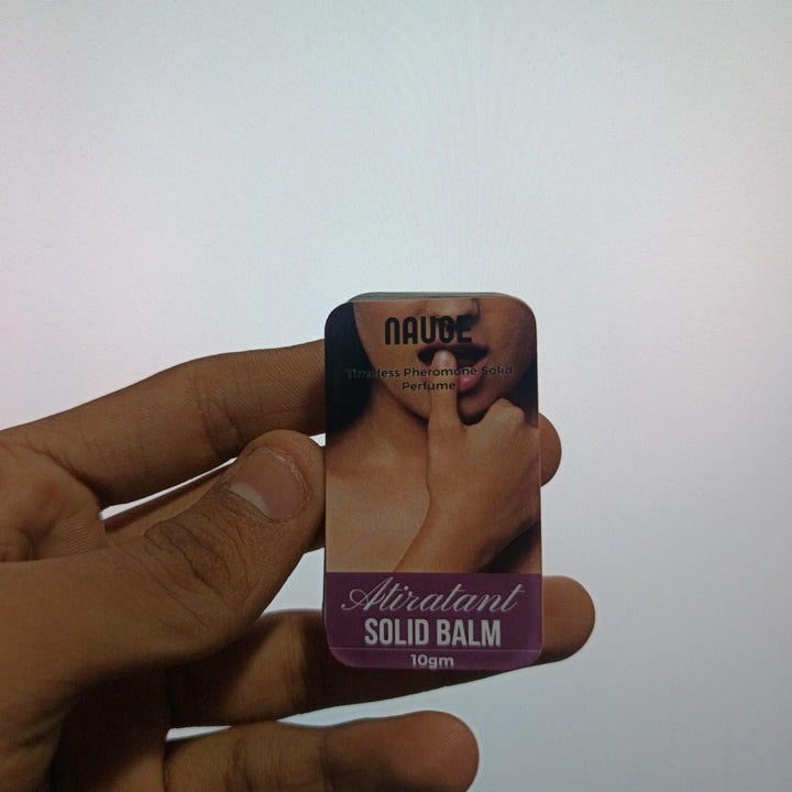 Hand holding Naude Atirarant pheromone solid perfume solid balm in compact 10g tin