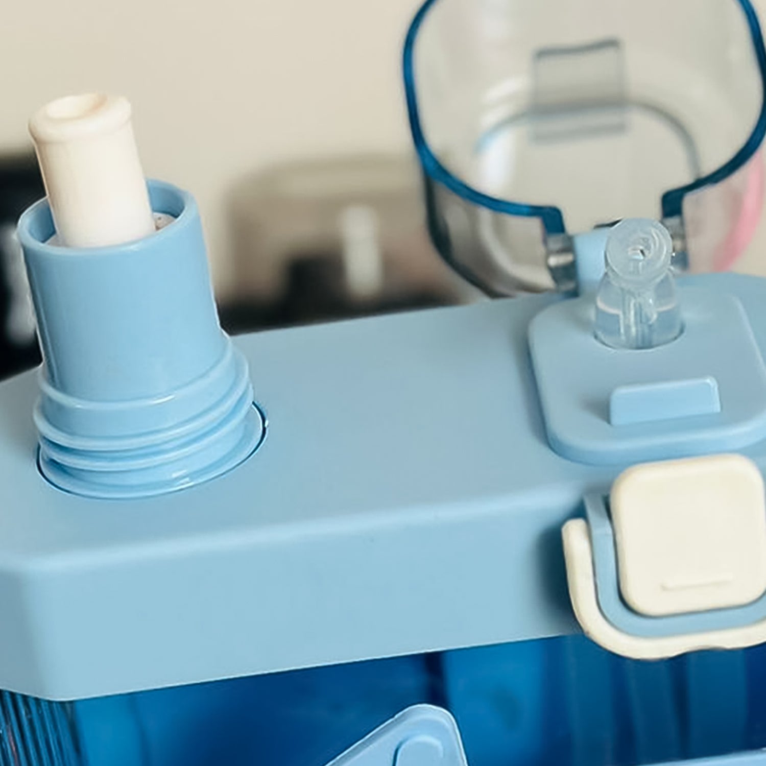 Close-up of a dual compartment water bottle showcasing the lid and spout features.