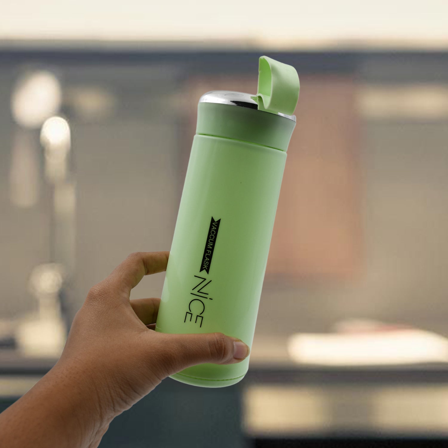 Green leak proof BPA-free water bottle held in hand for convenient hydration