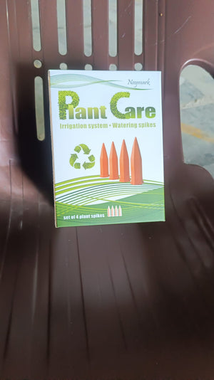 Set of 4 self watering spikes for plants arranged on a green and white packaging box
