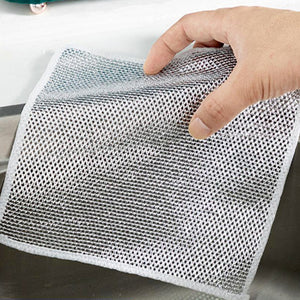 Non-scratch stainless steel scrubber being held for efficient kitchen cleaning without damaging surfaces