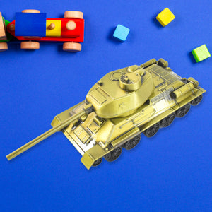 Nostalgia tank home decoration in gold color, surrounded by colorful building blocks and a toy train