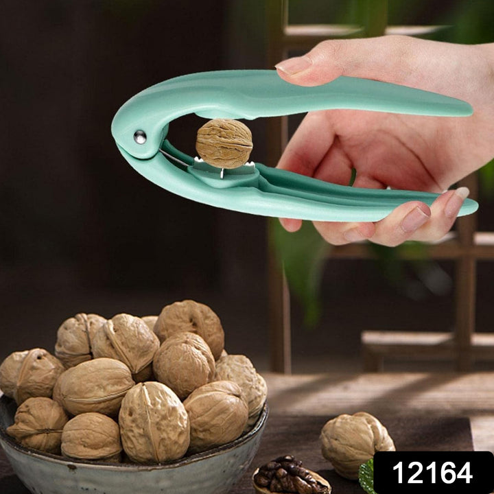 Superior eMart nutcracker chestnut opener in teal held by hand cracking a walnut over a bowl of nuts
