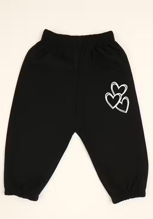 Black jogger pants for toddlers or kids, featuring an elastic waistband and cuffs, with a white outline graphic of three hearts on the left hip, shown against a plain off-white background.