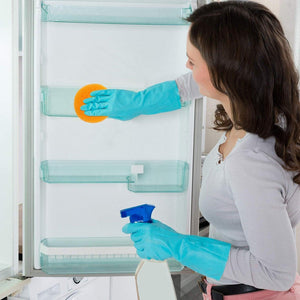 Woman cleaning refrigerator shelves with orange nylon scrubbers pack of 12 for effective cleaning