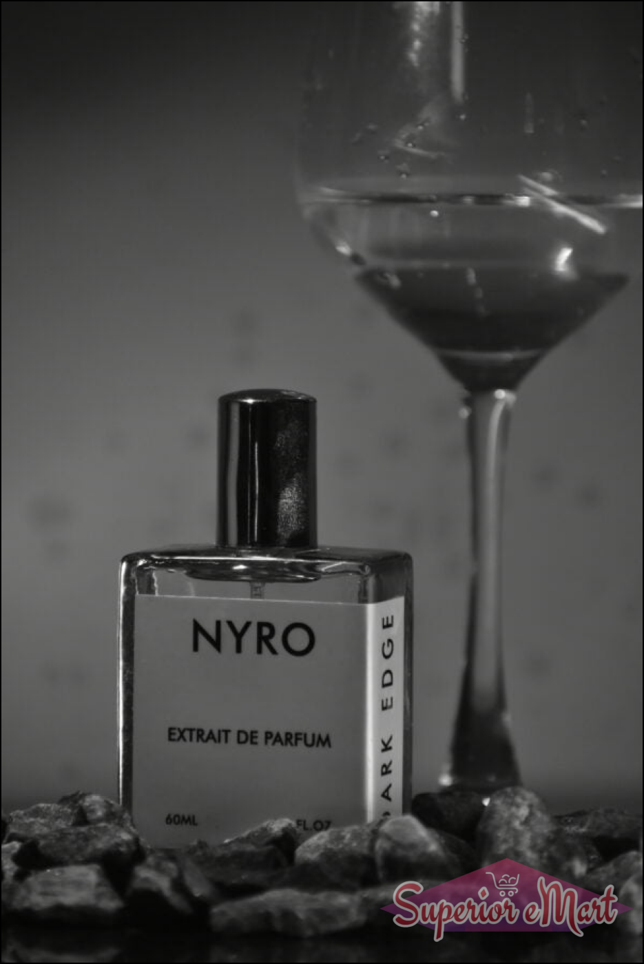Nyro Extrait de Parfum bottle with dark edge design and stones, set with a glass in the background