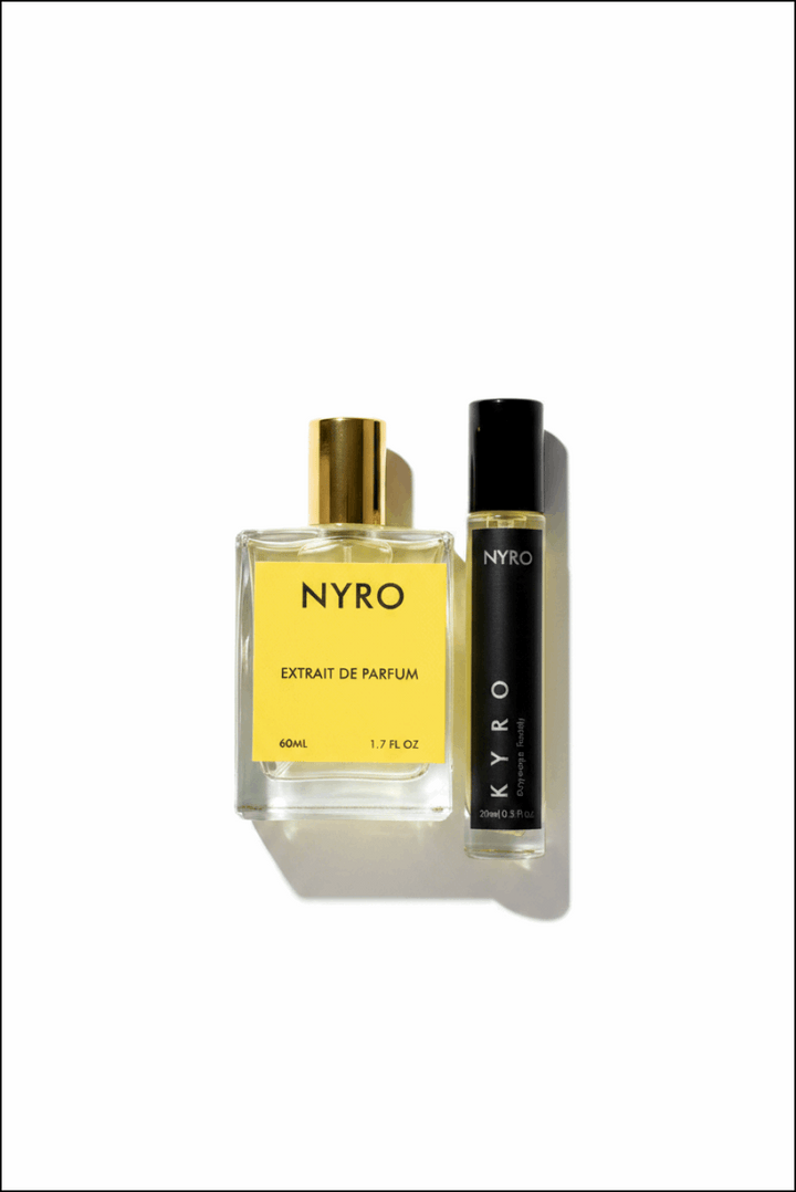 Two Nyro perfume bottles, one yellow and one black, on a white background