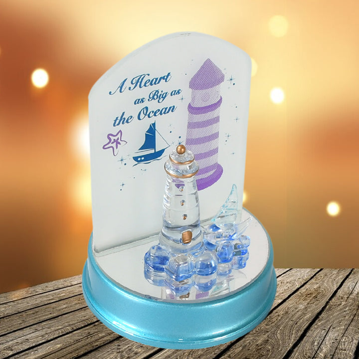 Ocean Lighthouse night light with decorative text and shimmering base for a calming home decor accent