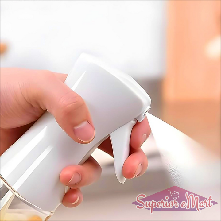 Hand holding a white oil spray bottle for cooking, perfect for even oil distribution on food