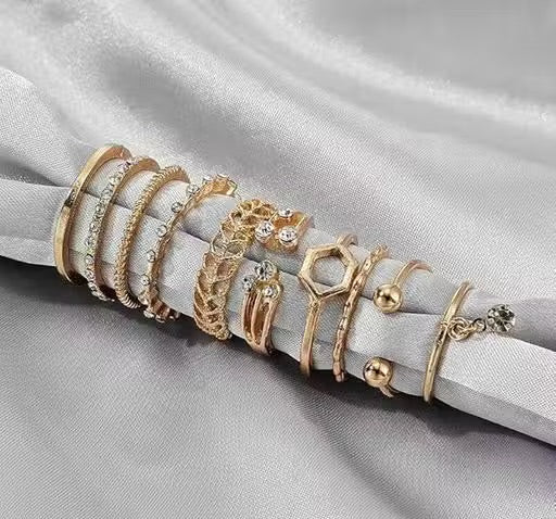 Set of gold rings on a gray fabric background