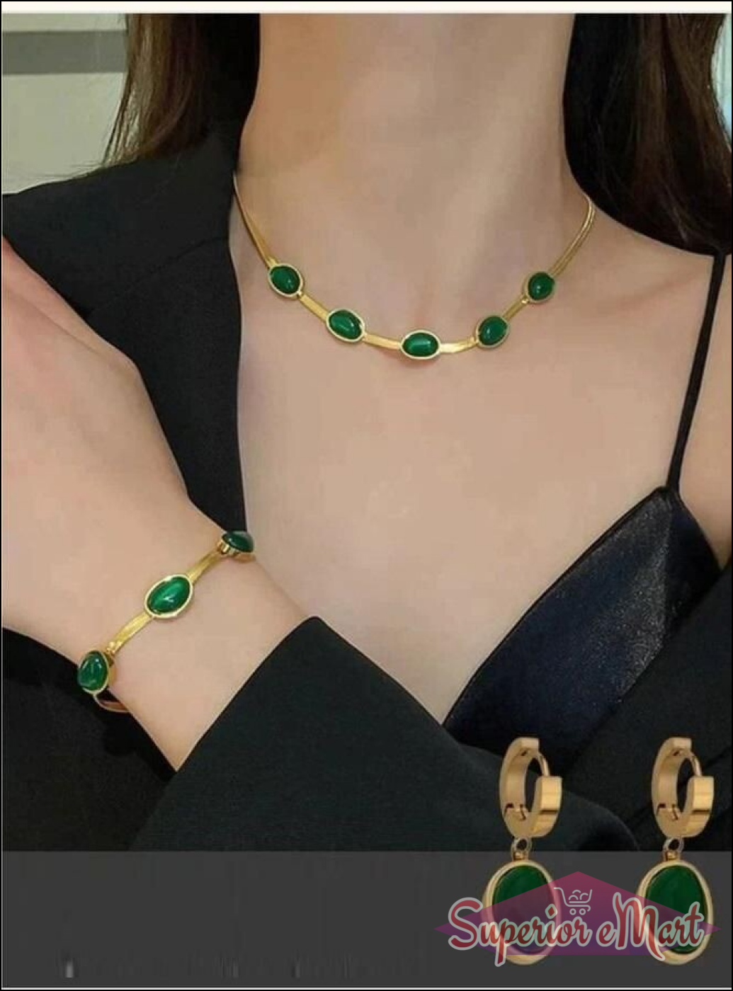 Gold jewelry set featuring dark green oval stones, including a necklace, bracelet, and matching hoop drop earrings.