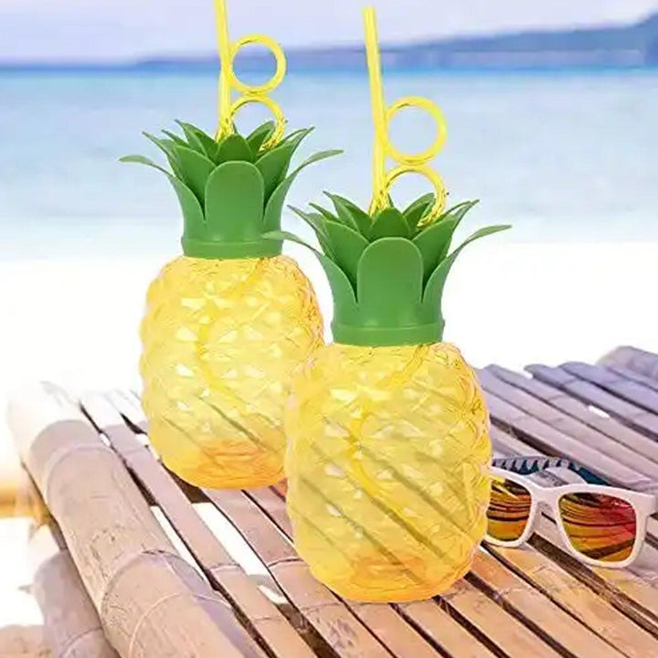 Colorful pineapple cup with straw set for summer parties and tropical drinks at the beach