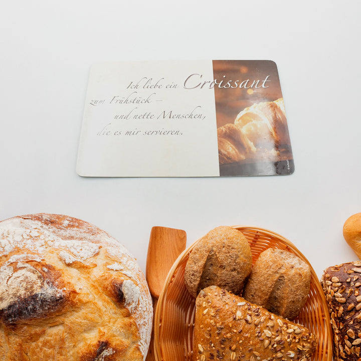 Superior eMart plastic kitchen chopping board shown with freshly baked bread and croissants