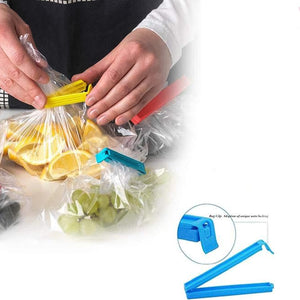 Hands using colorful plastic pouch sealer clips to seal bags of fruits and vegetables