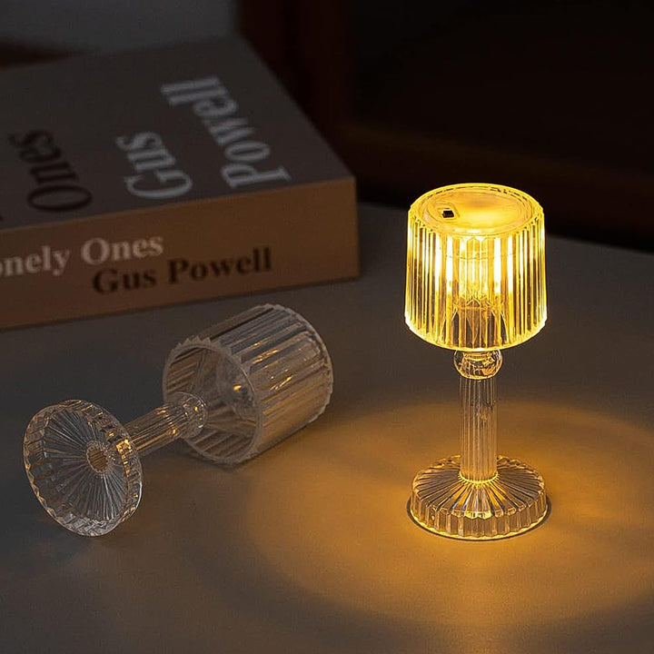 Portable acrylic LED desk lamp with a stylish design illuminating a dark workspace