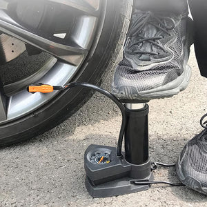 User operating a portable mini bike pump with pressure gauge for easy inflation of tires