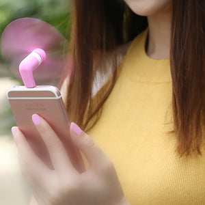 Compact portable USB fan attached to a smartphone for cooling on the go