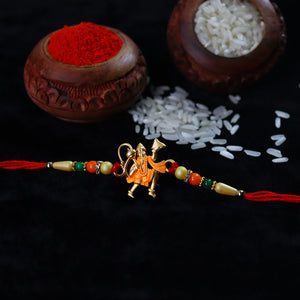 Powerful Hanuman designer Rakhi with colorful beads and red thread against black background