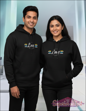 Two people wearing black hoodies with a design on a light background