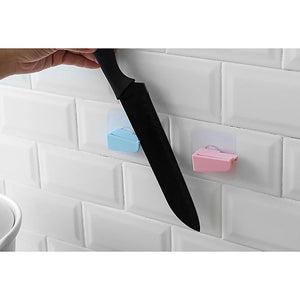 Punch free knife holder mounted on a wall with a hand placing a knife in it