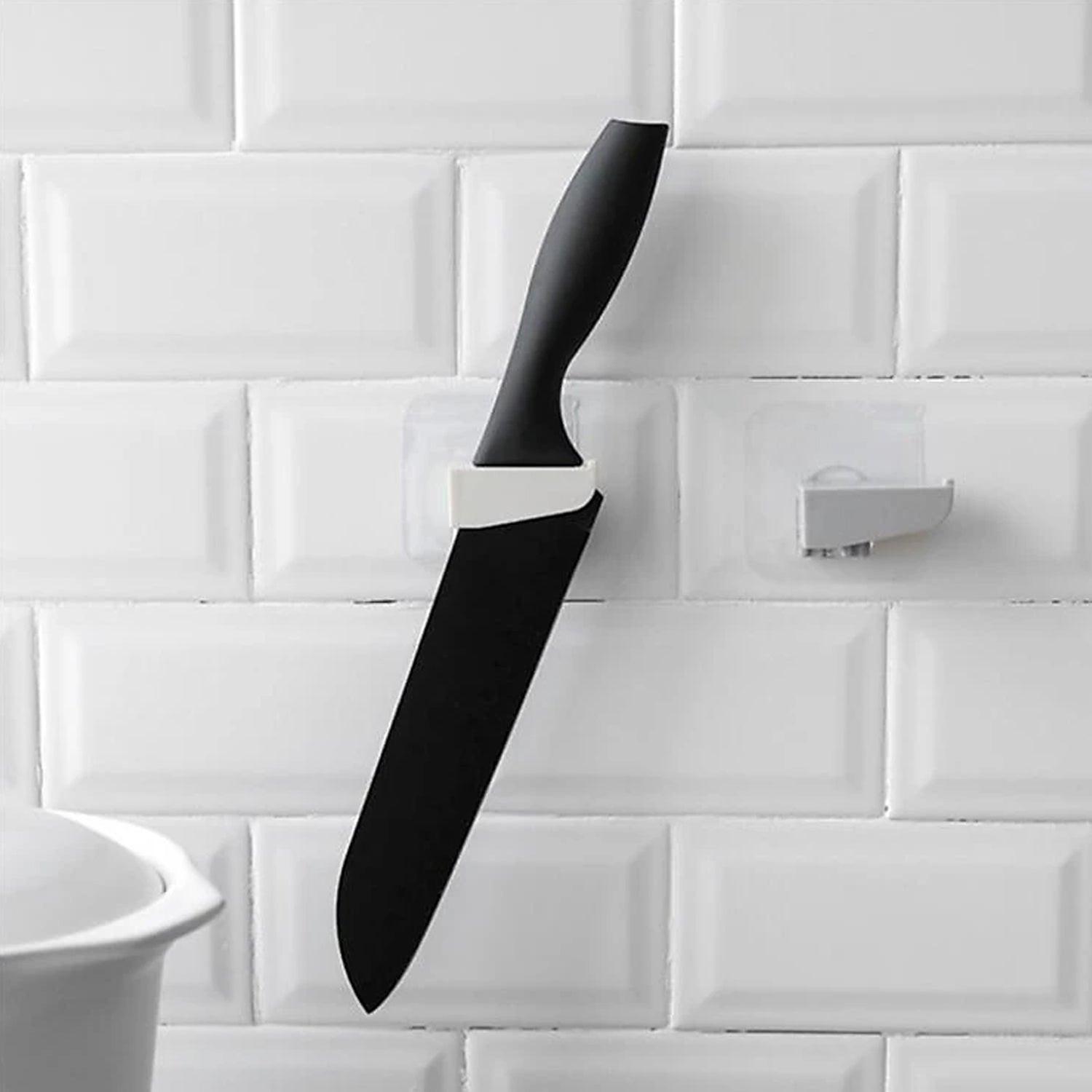 Punch free knife holder from Superior eMart holding a black kitchen knife on a tiled wall